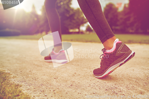 Image of close up of woman feet running on track from back
