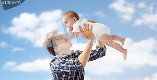 Image of happy young father playing with baby over blue sky