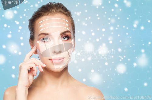 Image of beautiful young woman with lifting arrows on face