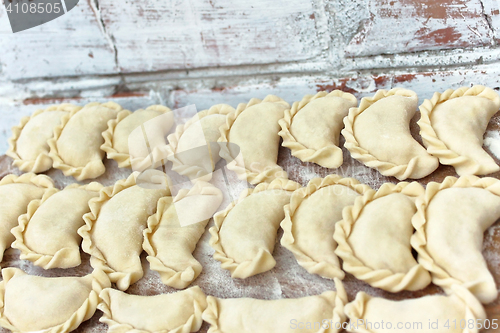 Image of Dumplings on the wooden board near break wall outdoors