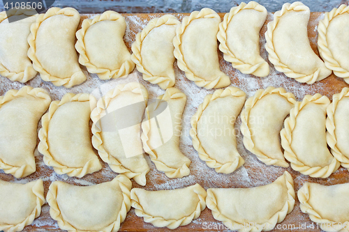 Image of Dumplings on the kitchen board with flour