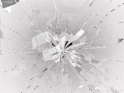 Image of Bullet hole and pieces of shattered or smashed glass 