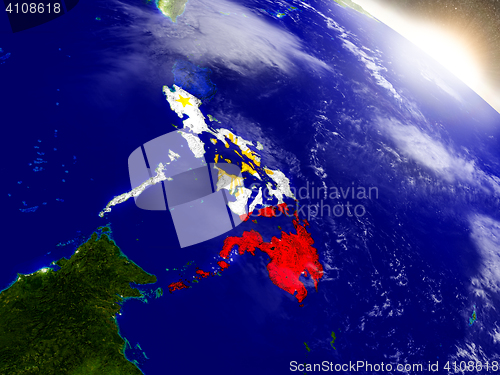 Image of Philippines with flag in rising sun