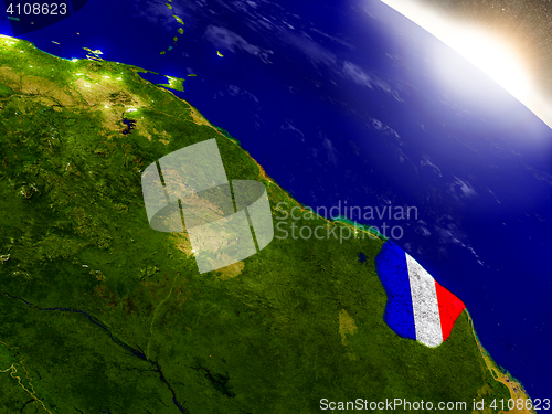 Image of French Guiana with flag in rising sun