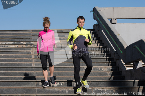 Image of young  couple jogging on steps