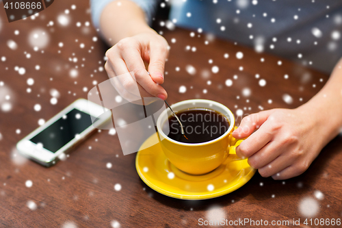 Image of  woman with smartphone and coffee