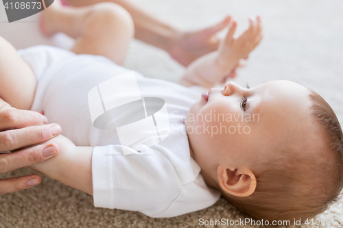 Image of close up of happy little baby and mother hands