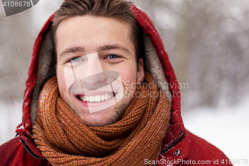 Image of close up of happy man in winter jacket with hood