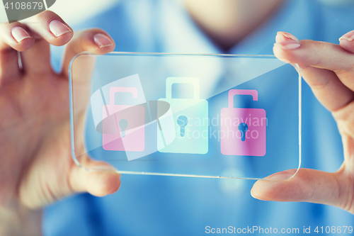 Image of close up of woman with transparent smartphone