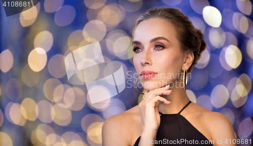 Image of beautiful woman in black wearing diamond jewelry