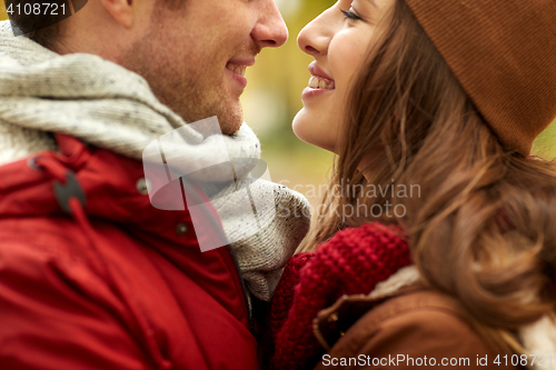 Image of close up of happy young couple kissing outdoors