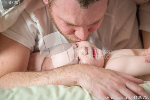 Image of Mixed Race Chinese and Caucasian Baby Boy Laying In Bed with His