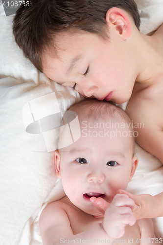 Image of Mixed Race Chinese and Caucasian Baby Brothers Having Fun Laying