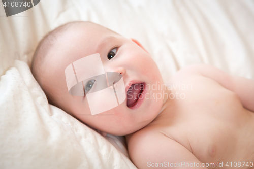 Image of Mixed Race Baby Boy Having Fun on His Blanket