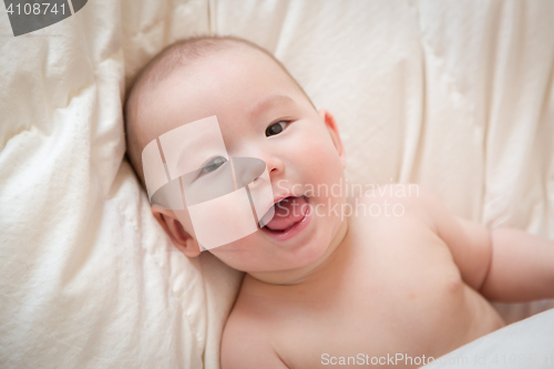 Image of Mixed Race Baby Boy Having Fun on His Blanket