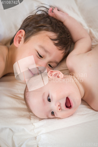 Image of Mixed Race Chinese and Caucasian Baby Brothers Having Fun Laying