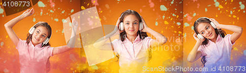 Image of The cute cheerful little girl on orange background