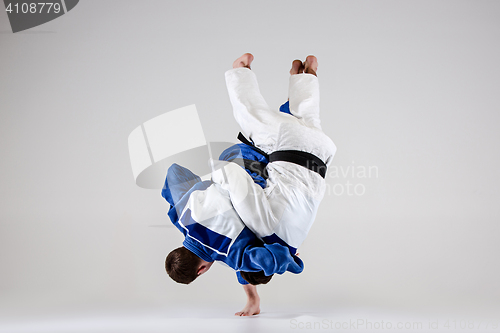 Image of The two judokas fighters fighting men