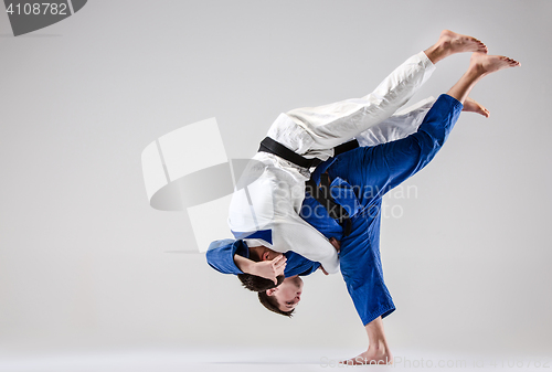 Image of The two judokas fighters fighting men