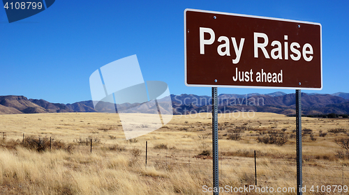 Image of Pay Raise brown road sign