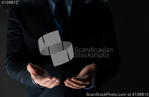 Image of close up of businessman holding something in hands