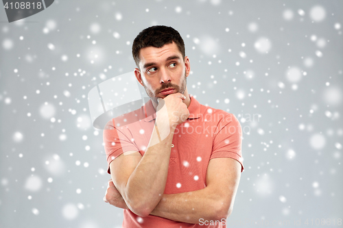 Image of man thinking over snow background