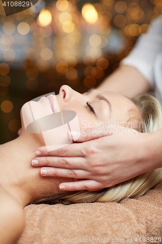 Image of close up of woman having face massage in spa