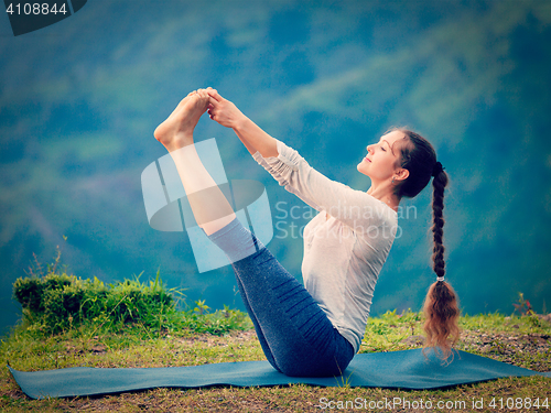 Image of Woman doing Ashtanga Vinyasa Yoga asana outdoors