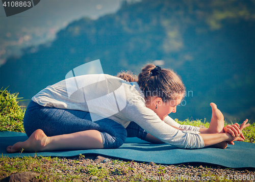 Image of Woman in Tiryam-Mukha Eka-Pada Paschimottanasana asana stretchin