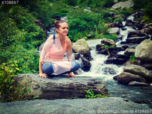 Image of Woman doing  Ashtanga Vinyasa Yoga  arm balance asana Tolasana