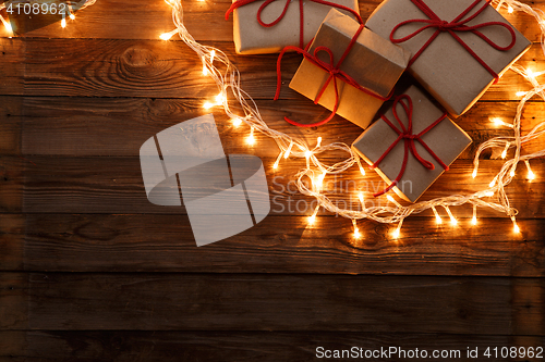 Image of Christmas gifts on wooden background