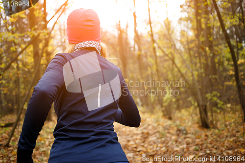 Image of Blonde sportswoman jogging in morning
