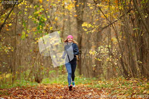 Image of Slender girl running in park