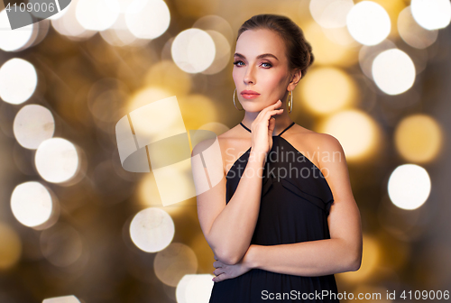 Image of beautiful woman in black wearing diamond jewelry