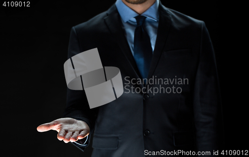 Image of close up of businessman holding something on hand