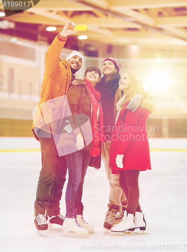 Image of happy friends taking selfie on skating rink