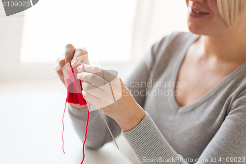 Image of woman hands knitting with needles and yarn