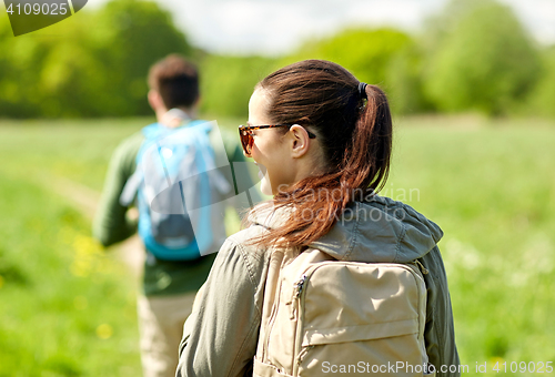 Image of close up of couple with backpacks hiking outdoors