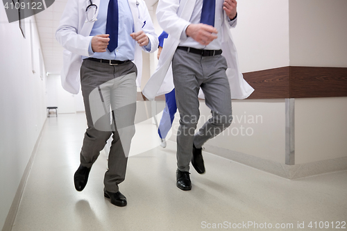 Image of close up of medics or doctors running at hospital