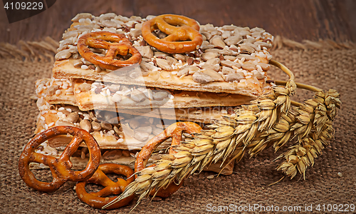 Image of Pile cereal cookies with seeds and wheat ears on sacking