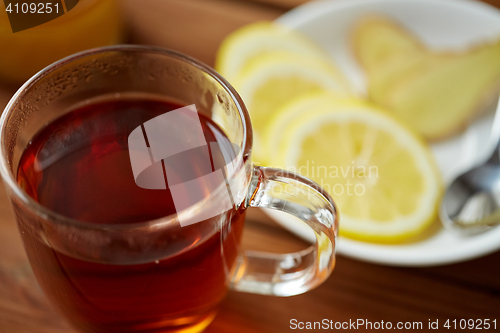 Image of tea cup with lemon and ginger on plate