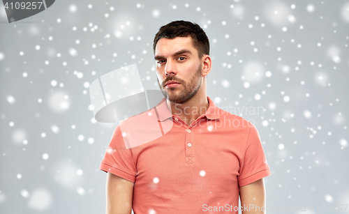 Image of suspicious man thinking over snow background