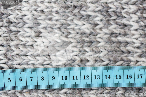 Image of close up of knitted item with measuring tape