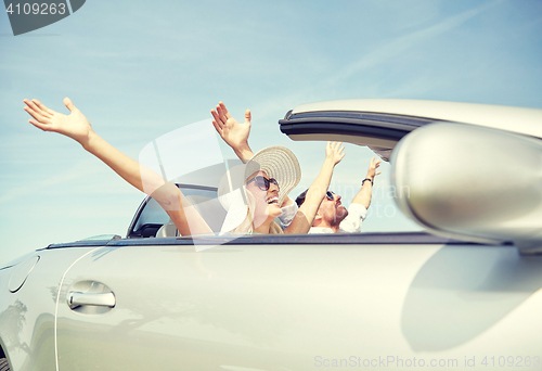 Image of happy man and woman driving in cabriolet car