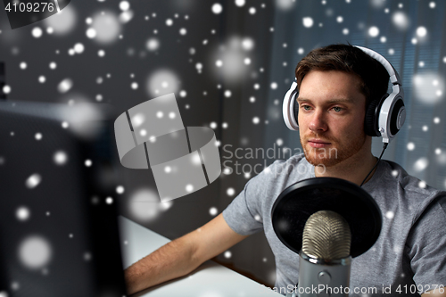 Image of man in headset playing computer video game at home