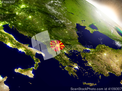 Image of Macedonia with flag in rising sun