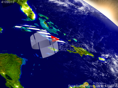 Image of Cuba with flag in rising sun