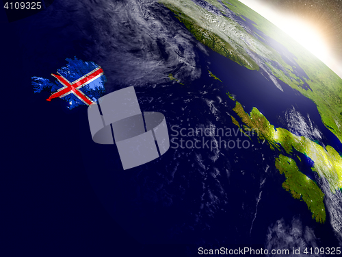 Image of Iceland with flag in rising sun