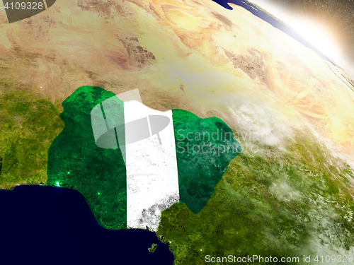Image of Nigeria with flag in rising sun