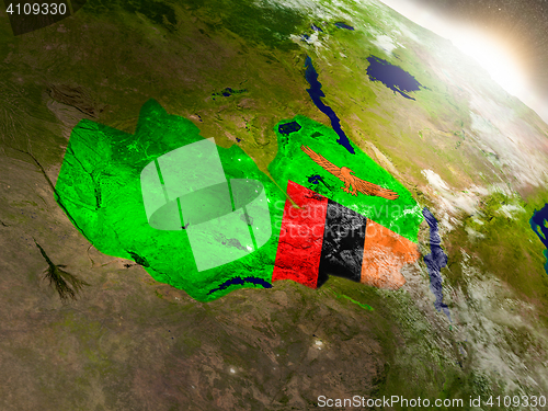 Image of Zambia with flag in rising sun